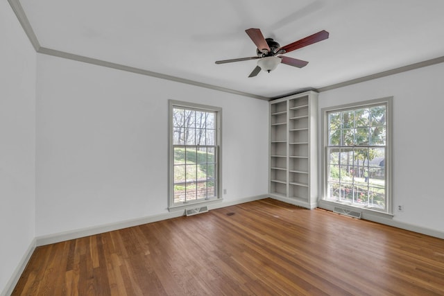 spare room featuring wood-type flooring, ornamental molding, and ceiling fan