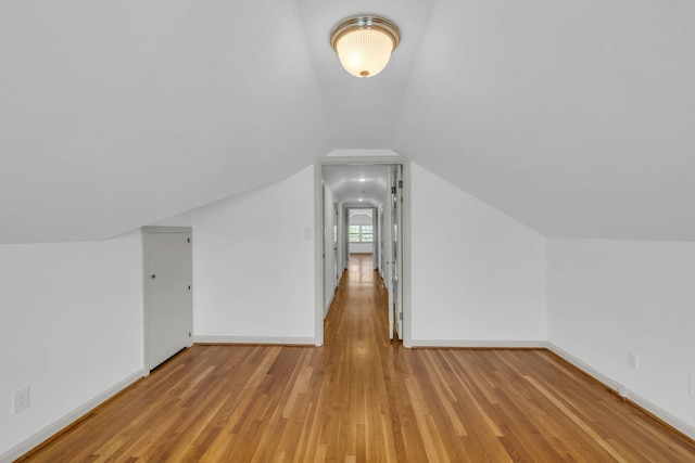 additional living space with lofted ceiling and light hardwood / wood-style floors