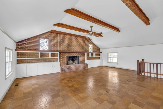 unfurnished living room featuring ceiling fan, vaulted ceiling with beams, parquet floors, a brick fireplace, and brick wall