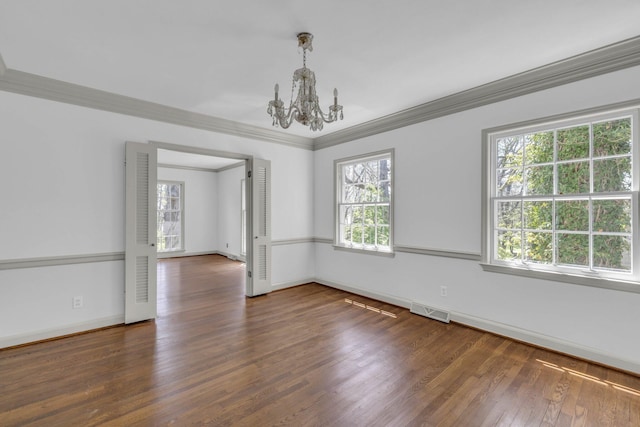 spare room featuring crown molding, dark hardwood / wood-style flooring, and plenty of natural light