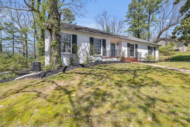 ranch-style home featuring a front lawn and central AC