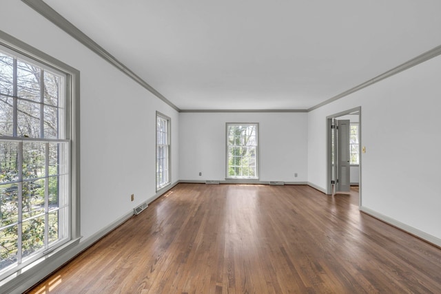 empty room with wood-type flooring and ornamental molding