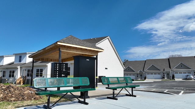 exterior space featuring a garage and a mail area