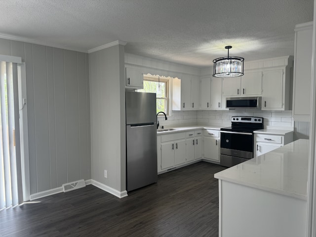 kitchen featuring white cabinetry, stainless steel appliances, and dark wood-type flooring