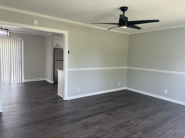 spare room with dark hardwood / wood-style floors, ceiling fan, and a textured ceiling