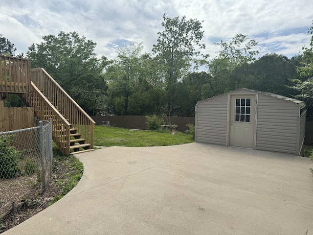 exterior space featuring a wooden deck and an outdoor structure