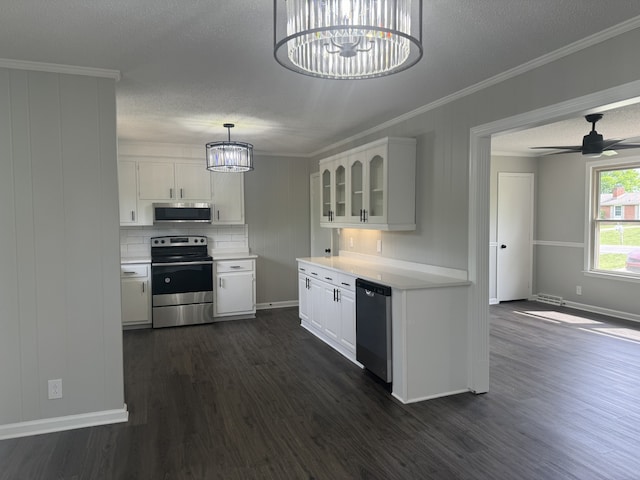 kitchen with pendant lighting, appliances with stainless steel finishes, dark hardwood / wood-style flooring, and white cabinetry