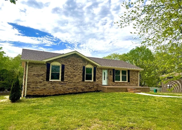 ranch-style home with a front lawn