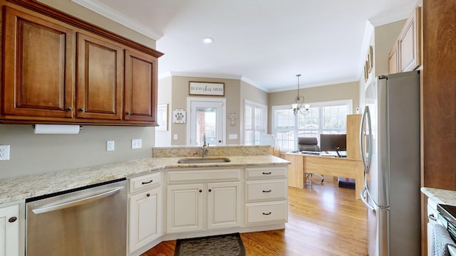 kitchen with light hardwood / wood-style flooring, stainless steel appliances, a chandelier, crown molding, and sink