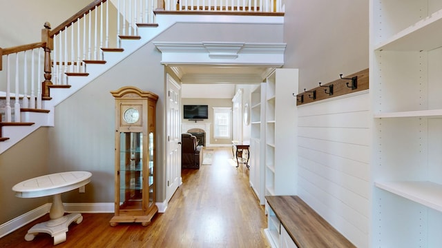 interior space featuring light wood-type flooring and a high ceiling