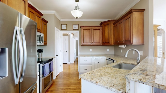 kitchen featuring appliances with stainless steel finishes, sink, crown molding, hanging light fixtures, and light stone countertops