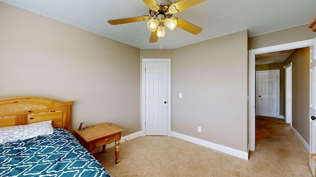 bedroom with ceiling fan and light colored carpet