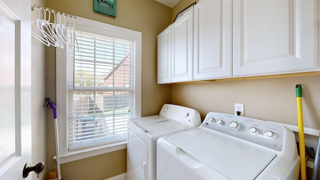 laundry area with washing machine and dryer and cabinets