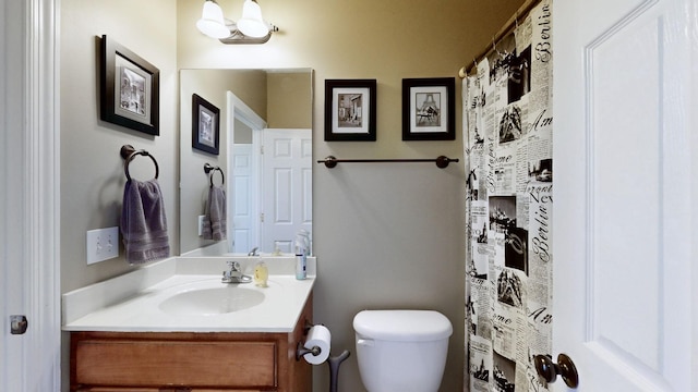 bathroom with toilet and vanity