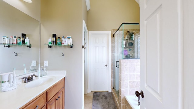 bathroom with tile patterned flooring, vanity, and a shower with door