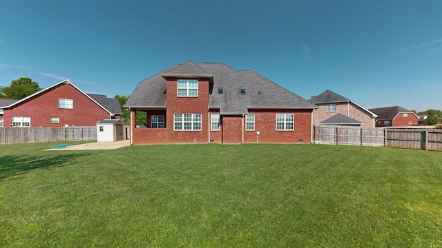 rear view of house featuring a shed, a patio, and a lawn