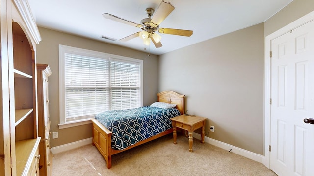 bedroom featuring light colored carpet and ceiling fan