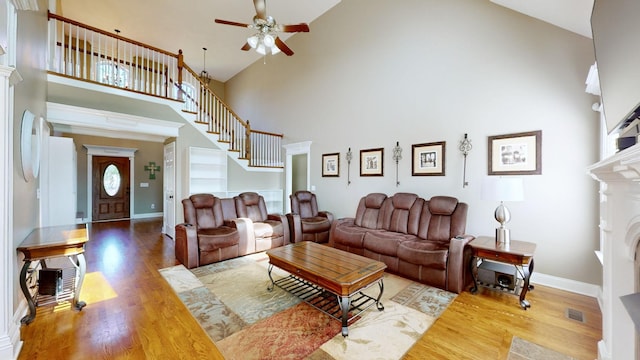 living room with high vaulted ceiling, hardwood / wood-style floors, and ceiling fan