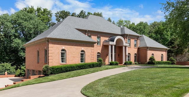 view of front of house with a garage and a front yard