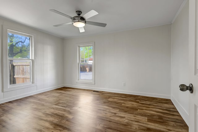 spare room with ceiling fan, crown molding, and dark hardwood / wood-style floors