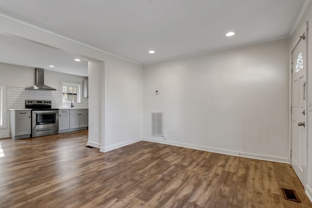 interior space featuring crown molding, dark wood-type flooring, and sink