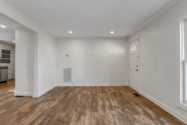 empty room with dark wood-type flooring and crown molding