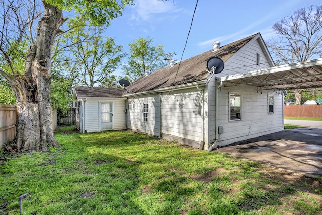 rear view of property with a yard