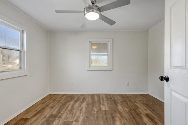 empty room with ornamental molding, ceiling fan, and dark hardwood / wood-style floors