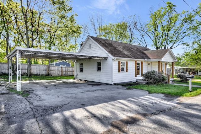 ranch-style house with a carport and covered porch