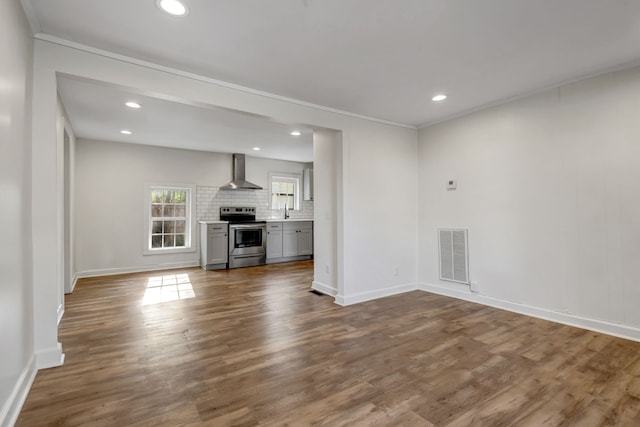 unfurnished living room with sink and dark hardwood / wood-style floors