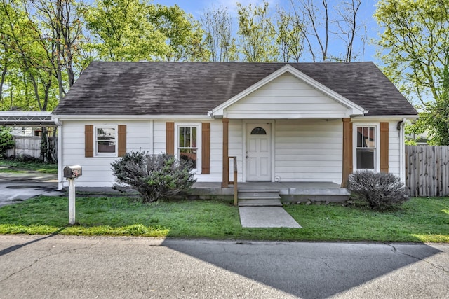 view of front facade with covered porch and a front yard