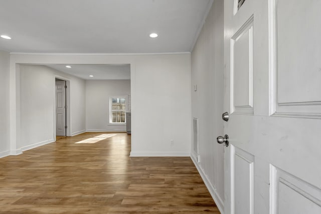 entrance foyer with crown molding and wood-type flooring