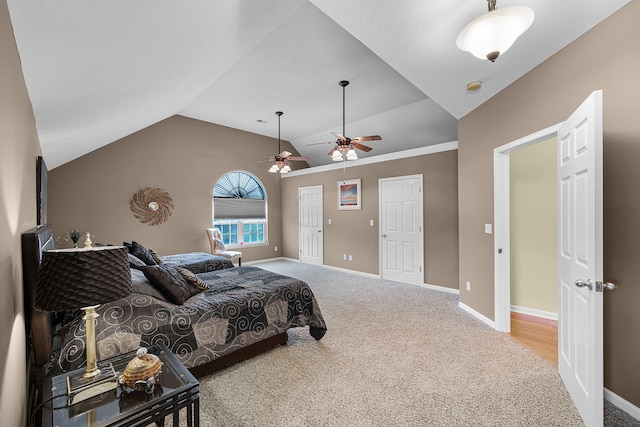 carpeted bedroom with ceiling fan and lofted ceiling