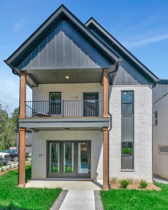 rear view of property featuring a balcony