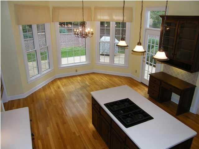 kitchen featuring a healthy amount of sunlight, light hardwood / wood-style flooring, hanging light fixtures, and a notable chandelier