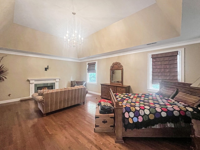 bedroom featuring hardwood / wood-style flooring, an inviting chandelier, and a tray ceiling