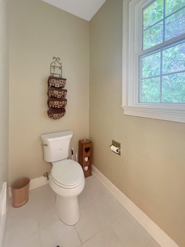 bathroom featuring tile floors and toilet