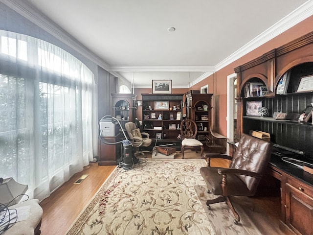 living area featuring ornamental molding and hardwood / wood-style flooring