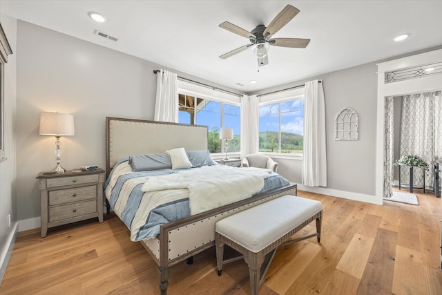 bedroom with light wood-type flooring and ceiling fan