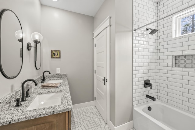 bathroom featuring tile patterned flooring, vanity, and tiled shower / bath