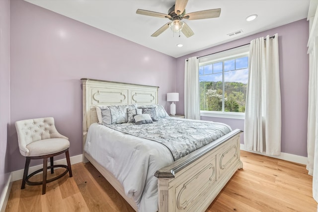 bedroom with light wood-type flooring and ceiling fan