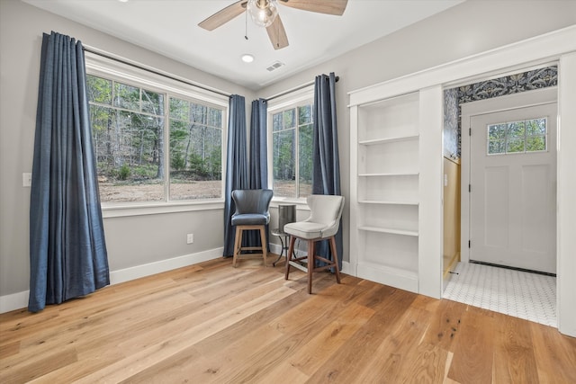 sitting room with light hardwood / wood-style flooring and ceiling fan