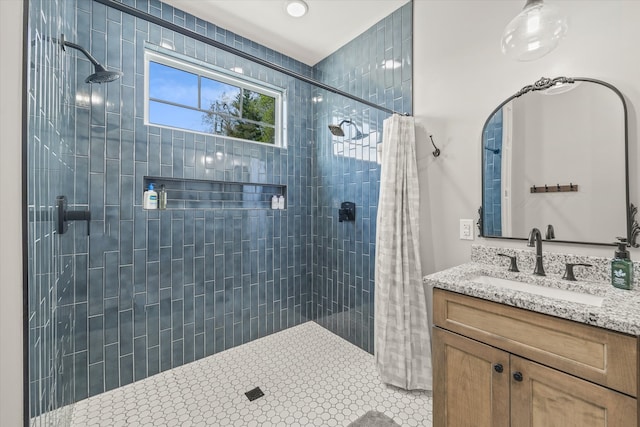 bathroom featuring walk in shower and vanity