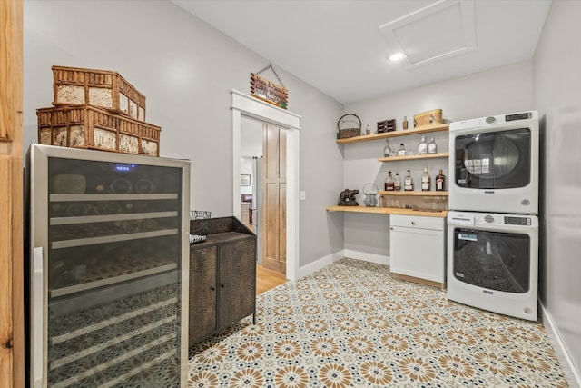 washroom featuring beverage cooler, indoor bar, and stacked washer / drying machine