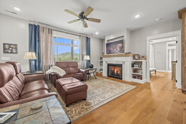 living room featuring ceiling fan and light wood-type flooring