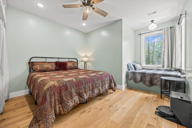 bedroom with light hardwood / wood-style flooring and ceiling fan