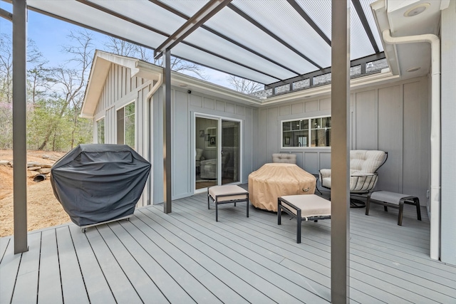 wooden deck with grilling area and a pergola