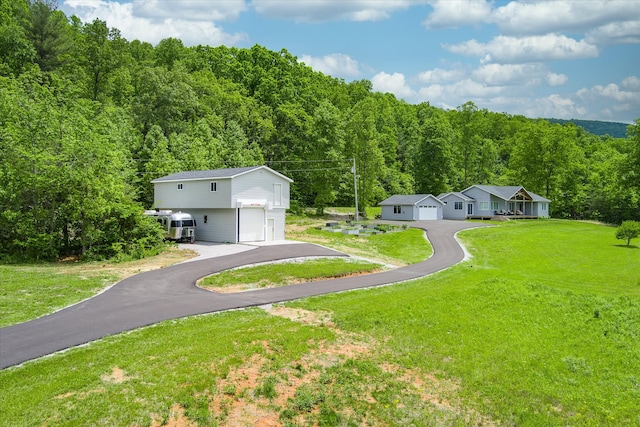 exterior space featuring a front lawn, an outdoor structure, and a garage