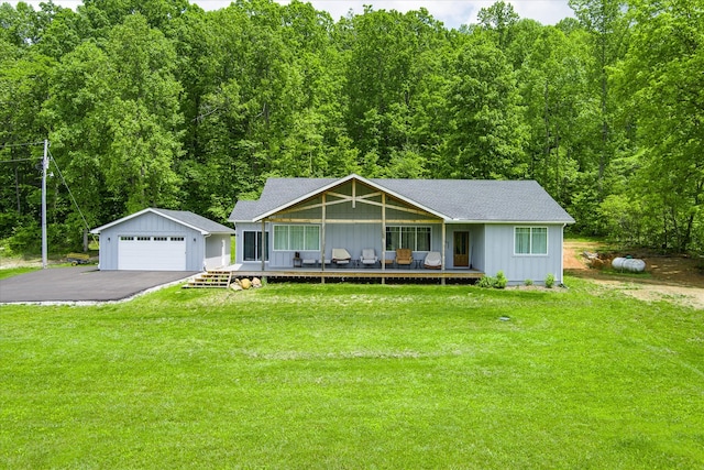 ranch-style house with an outbuilding, a front yard, a deck, and a garage