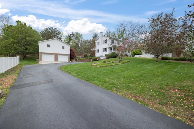 view of front of property featuring a garage and a front yard